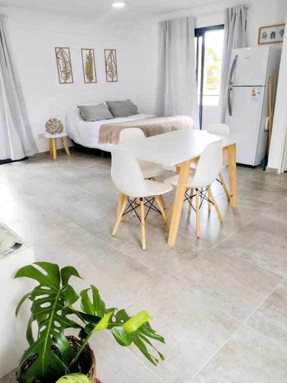 a room with a table and chairs and a bed at Hermoso depto en Temperley con cochera in Temperley
