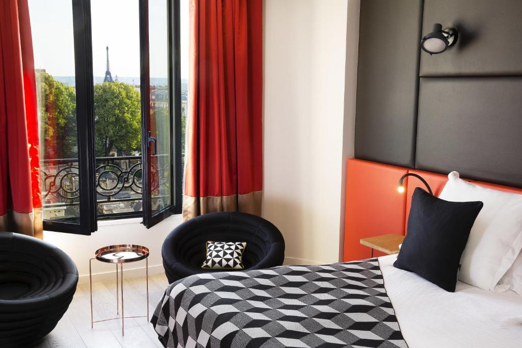 
a hotel room with a bed and a chair at Terrass" Hotel in Paris
