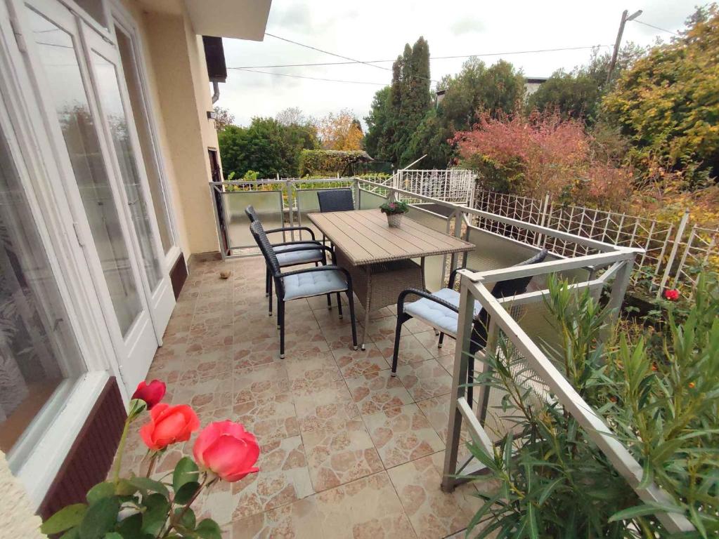 a patio with a table and chairs on a balcony at Holiday home in Revfülöp - Balaton 36498 in Révfülöp