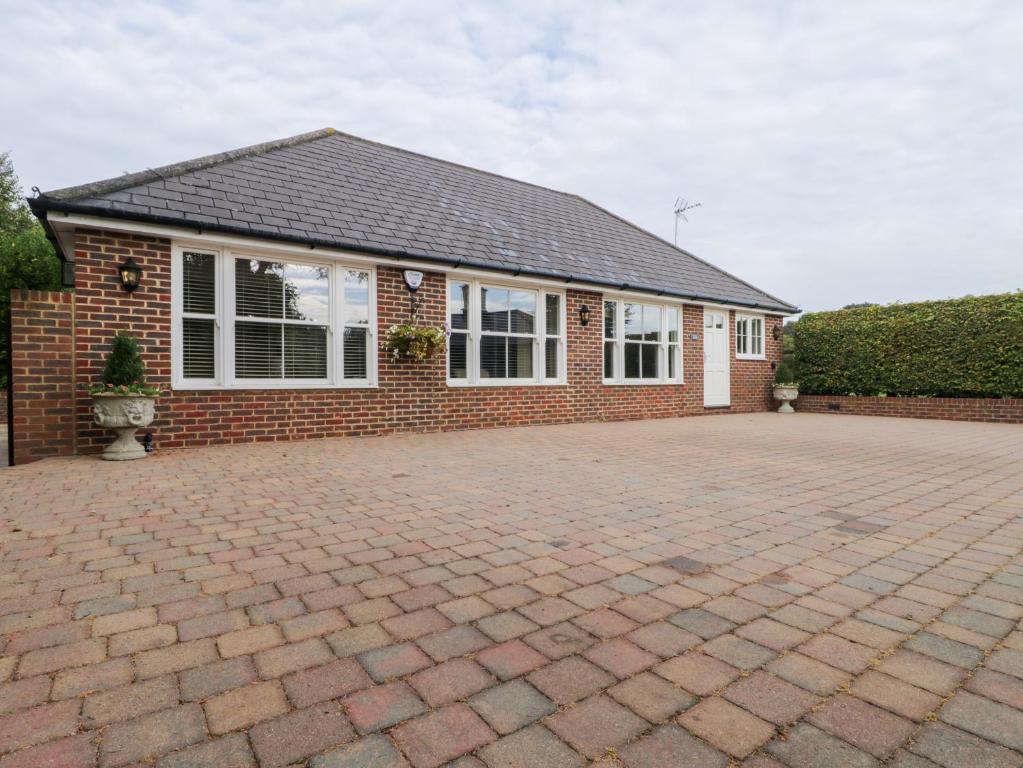 a brick house with a brick driveway at Little Aluph in Ashford