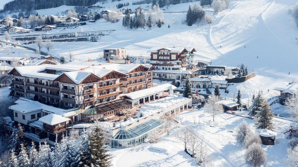 an aerial view of a resort in the snow at Hotel Oberforsthof in Sankt Johann im Pongau