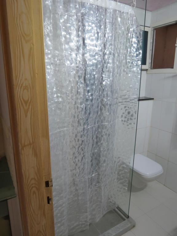 a glass shower in a bathroom with a toilet at Beautiful appartment with a glorious sea view in Monastir
