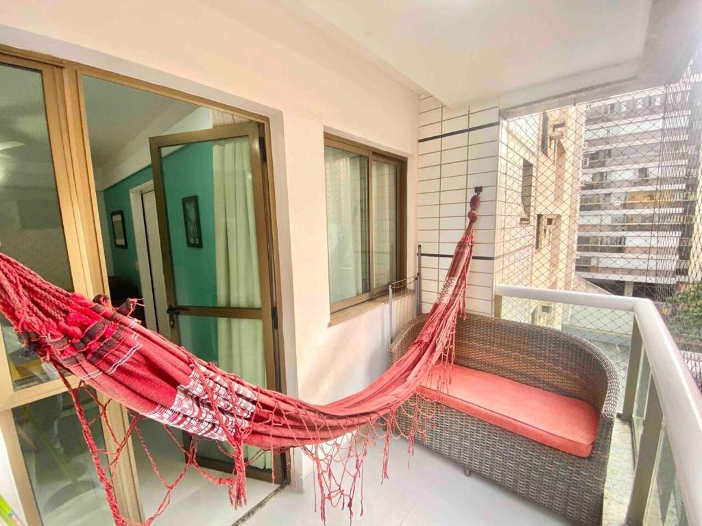 a hammock on the balcony of a house at Ocean Flat 606 in Vila Velha