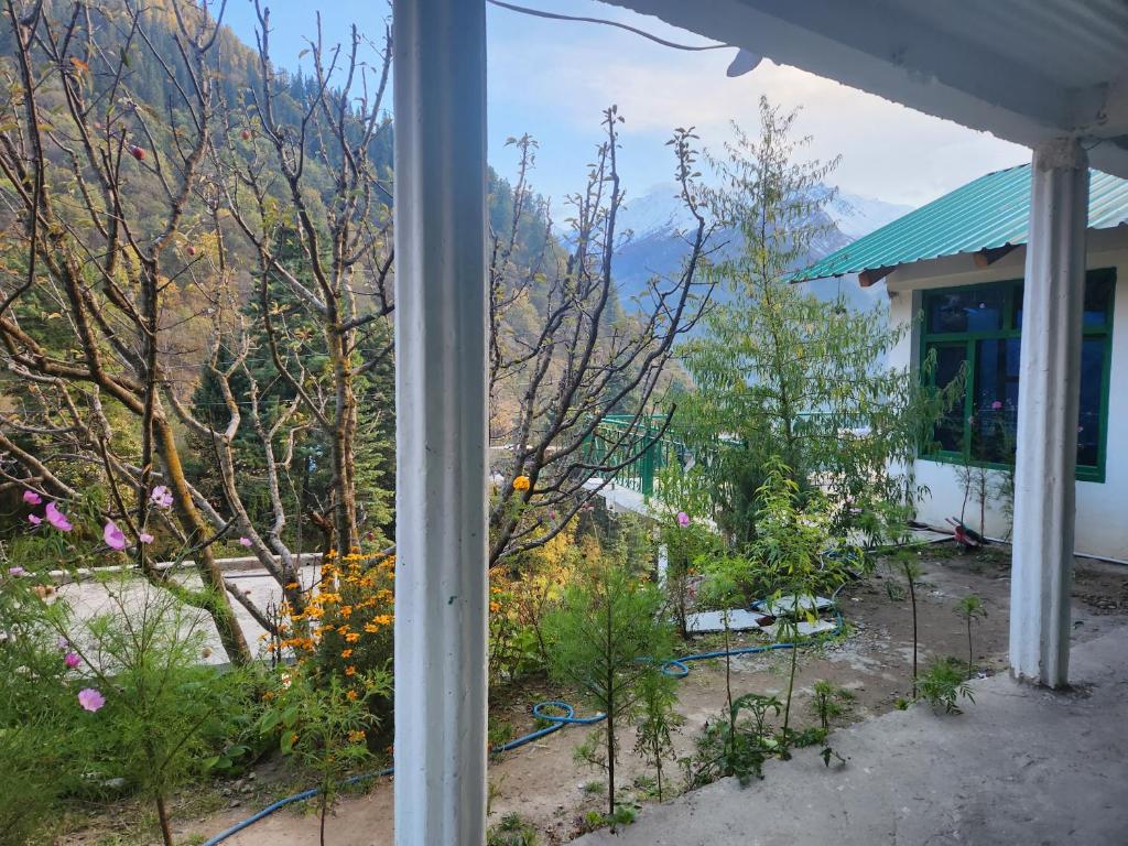 a view of a garden from the porch of a house at L'Ashrum Cafe & Inn in Tosh