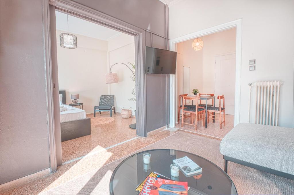 a living room with a glass table in a room at Koukaki Apartment in Athens