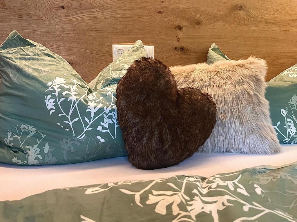 a couple of pillows sitting on top of a bed at Alpenstern Apartment Montafon in Sankt Gallenkirch