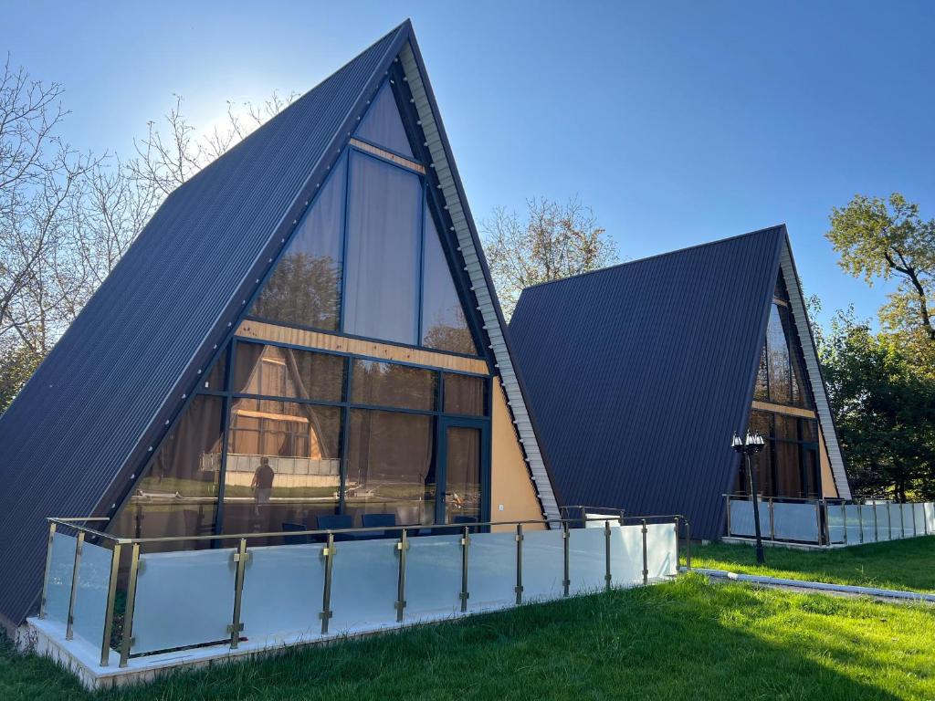 a house with a triangular roof and glass at Topchu Forest Ismayilli in Topçu