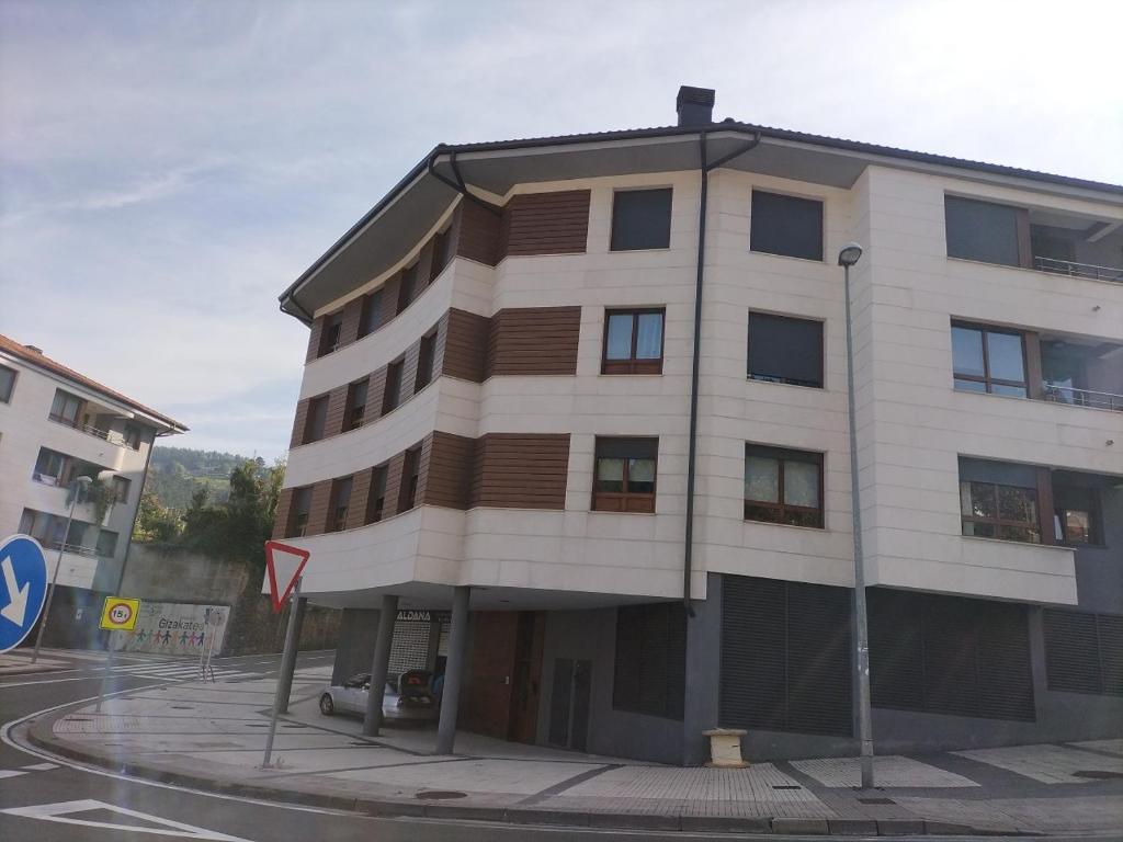 a large building on the corner of a street at ALTUNAHOME in Mutriku