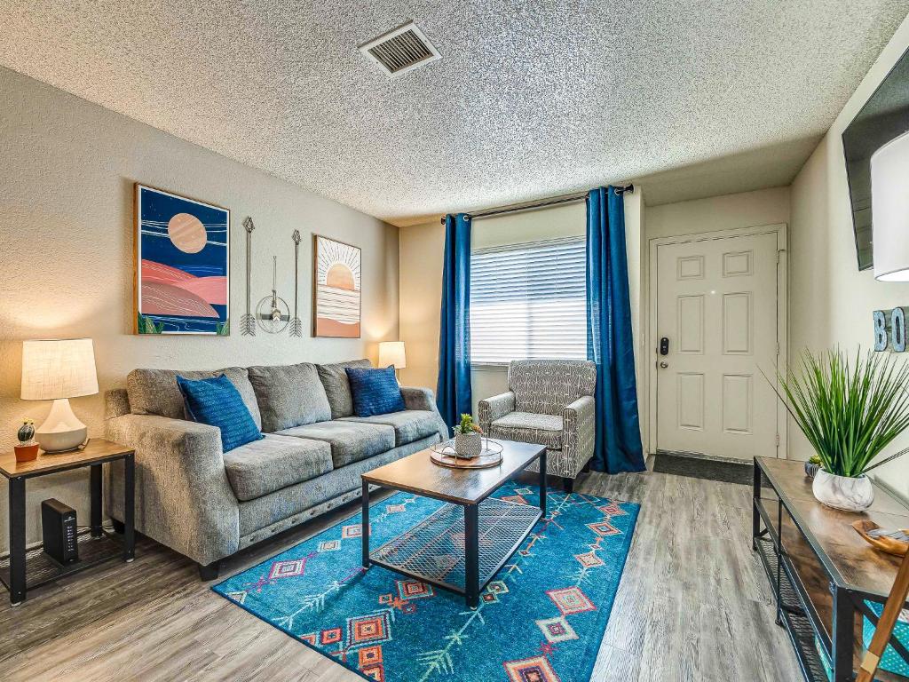 a living room with a couch and a table at OU Boomer, Pool & Gym, BBQ, Roku TVs, 100mb Internet, Washer & Dryer, just one mile to OU! in Norman