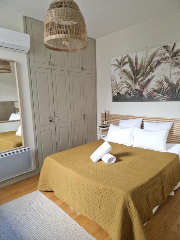 a bedroom with a bed with two towels on it at Atipyc Nimes in Nîmes