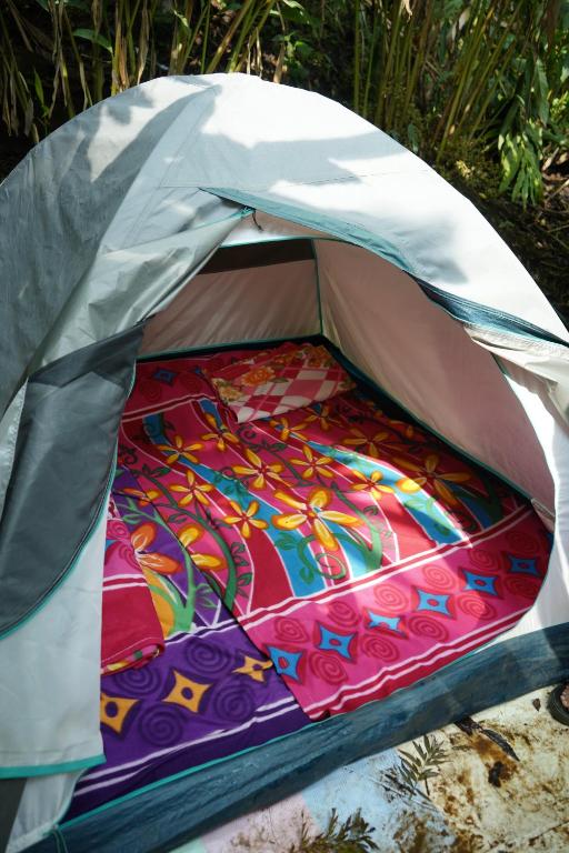 a tent with a colorful blanket in it at Willow Creek in Wayanad