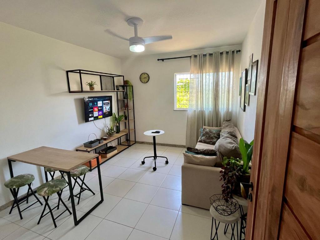 a living room with a couch and a table at Apartamento 3/4 ótima localização in Aracaju