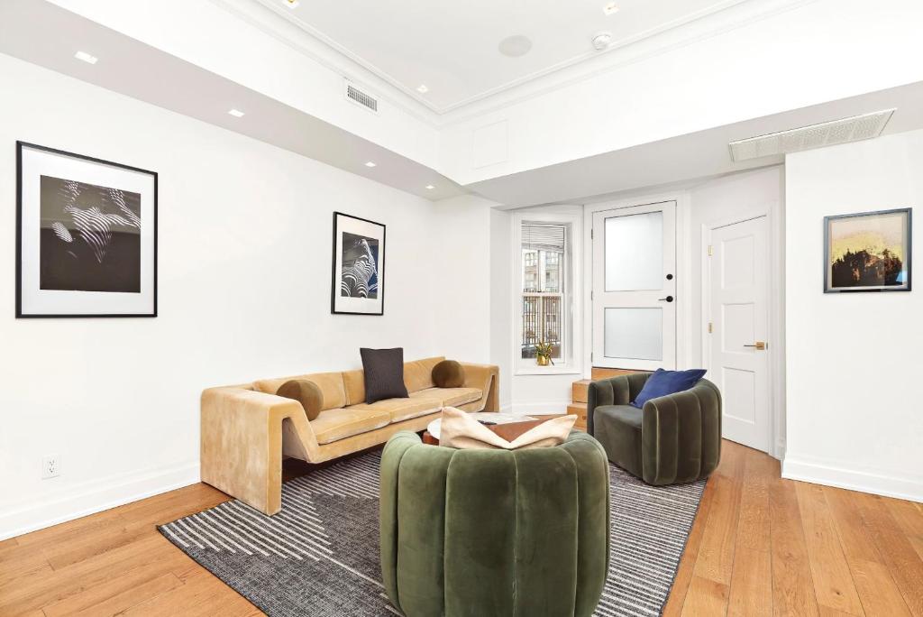 a living room with two couches and two chairs at Luxurious 5 BR Townhouse in New York