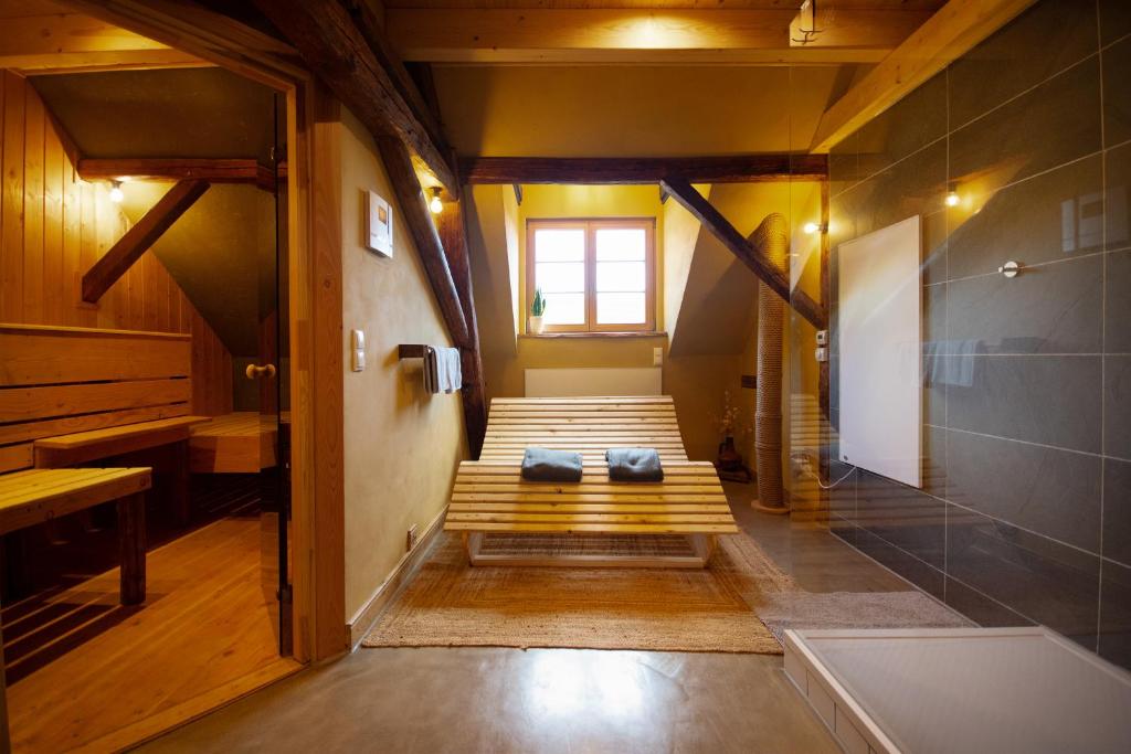 a bathroom with a bench in the middle of a room at Das haus in spay an der Mosel mit Sauna in Zell an der Mosel