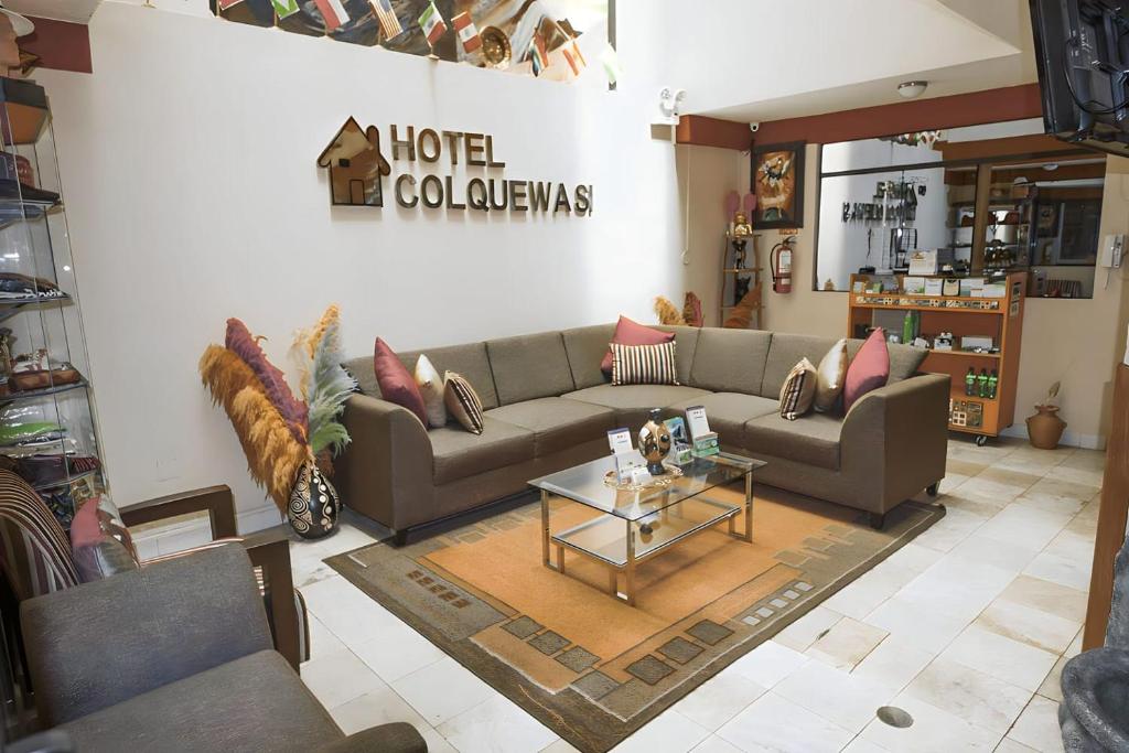 a living room with couches and a coffee table at Hotel Colquewasi in Cusco
