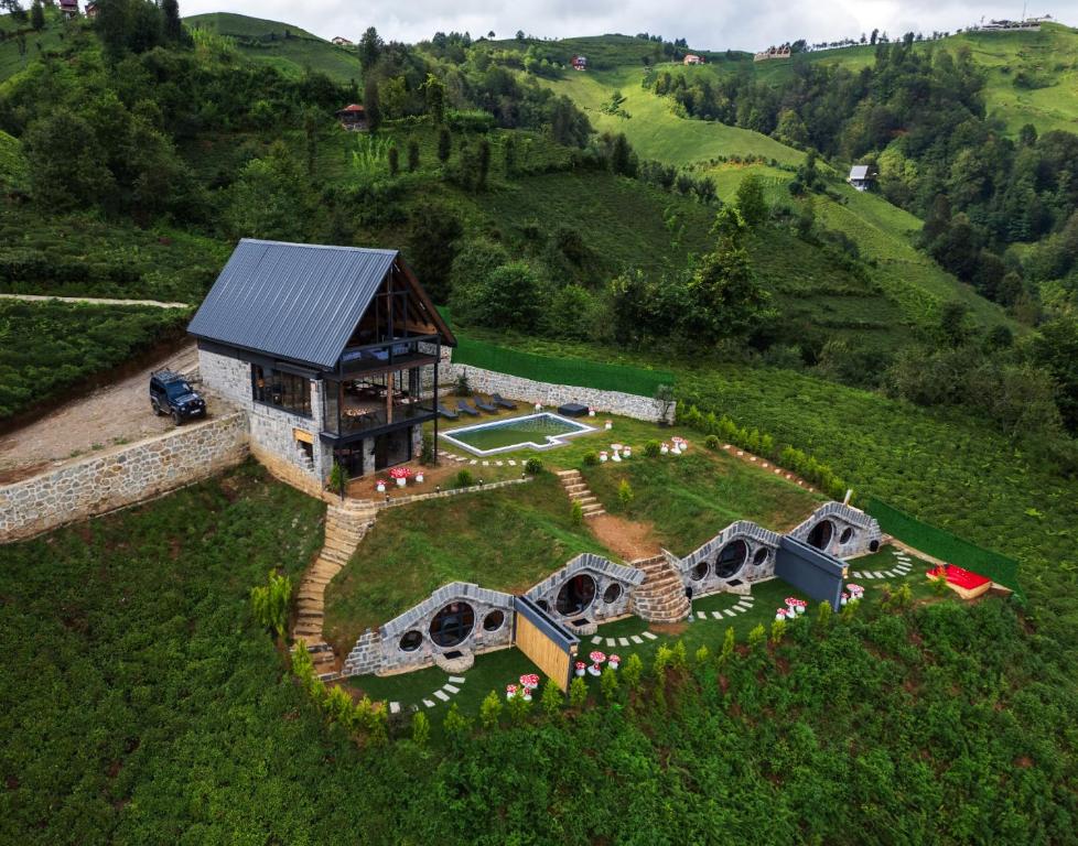 an aerial view of a house on a hill at Hobbit Chalet in Çamlıhemşin