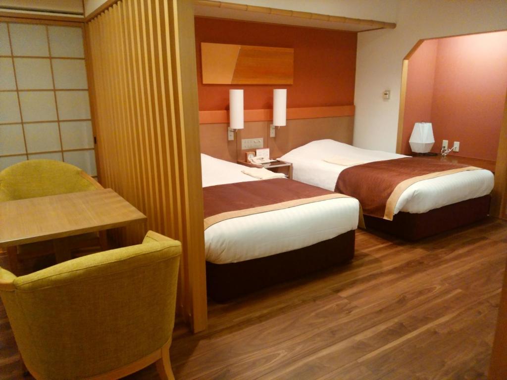 Postel nebo postele na pokoji v ubytování JR Hotel Clement Tokushima