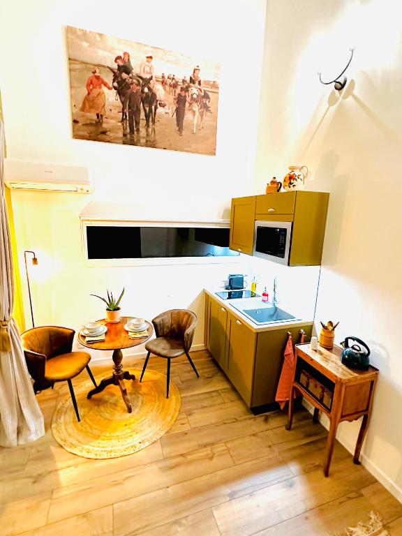 a kitchen with a table and chairs and a table at B&B Les Têtes de Mules - Adults Only in Gémenos