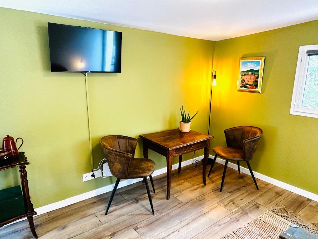 a dining room with a wooden table and chairs at B&B Les Têtes de Mules - Adults Only in Gémenos