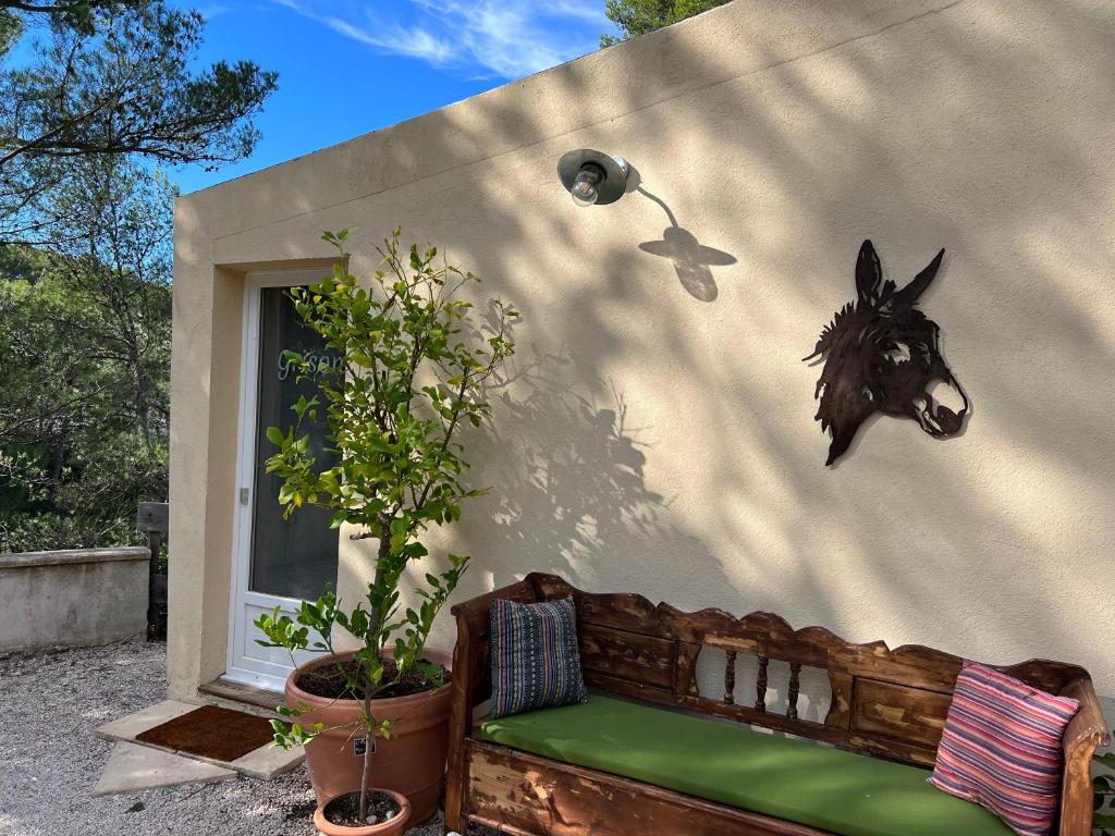 a building with a bench and a horse head on the wall at B&B Les Têtes de Mules - Adults Only in Gémenos