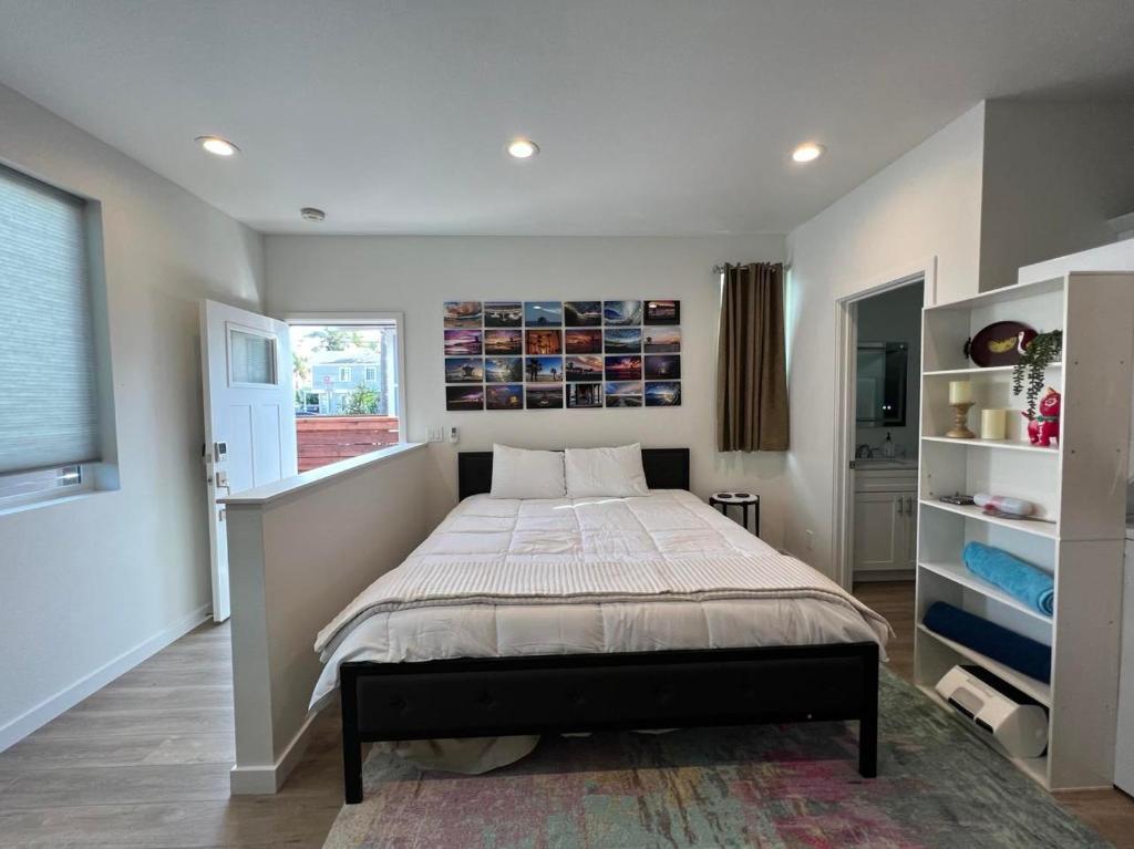 a bedroom with a large bed and a window at Beach Apartment in Huntington Beach