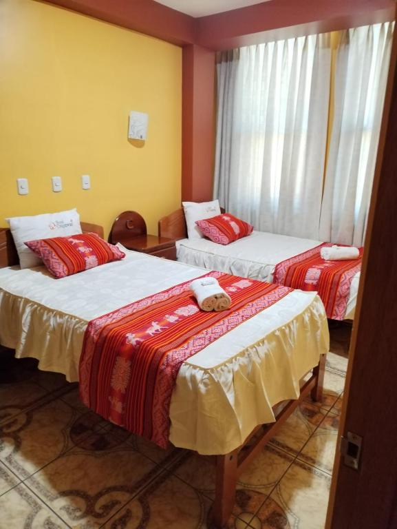 Postel nebo postele na pokoji v ubytování Hotel Colquewasi