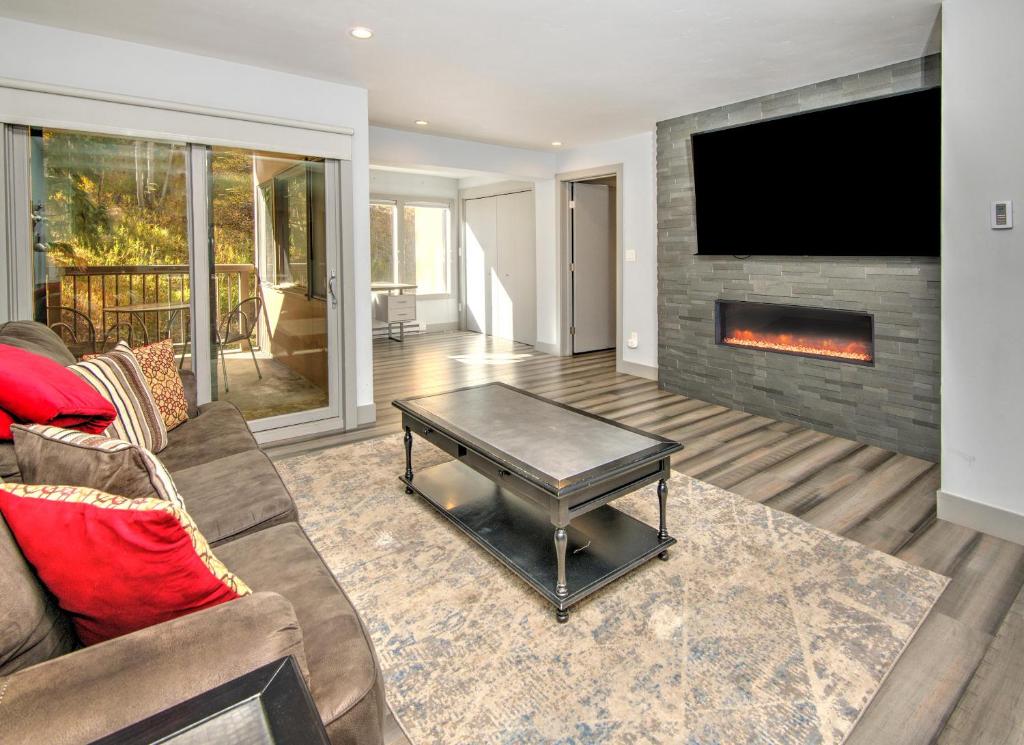a living room with a couch and a fireplace at Fall Ridge in Vail