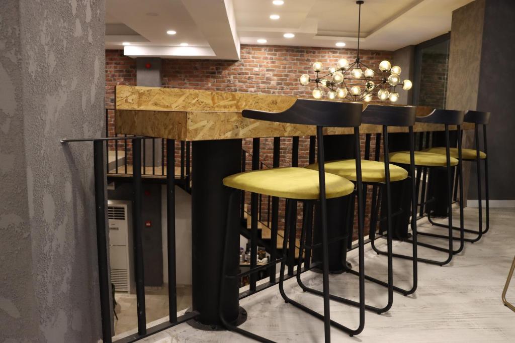 a bar with a row of stools in a room at Dab Hotel Ulus in Ankara