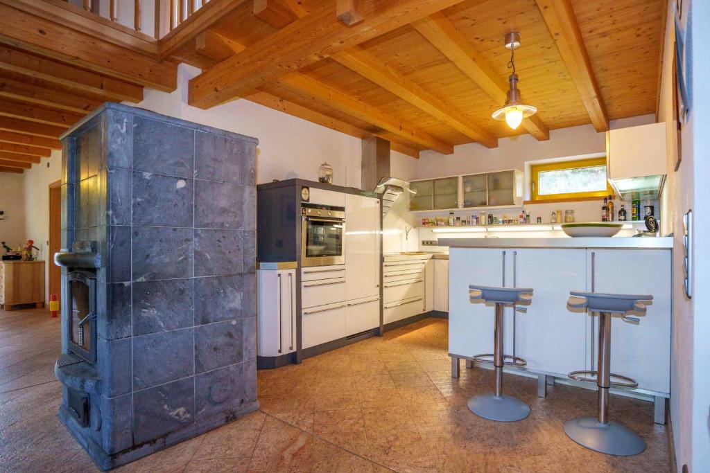 a large kitchen with a counter and a stove at Landhaus Seiffen in Seiffen