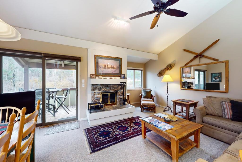 a living room with a couch and a fireplace at Moose Creek Lodge in Wilson