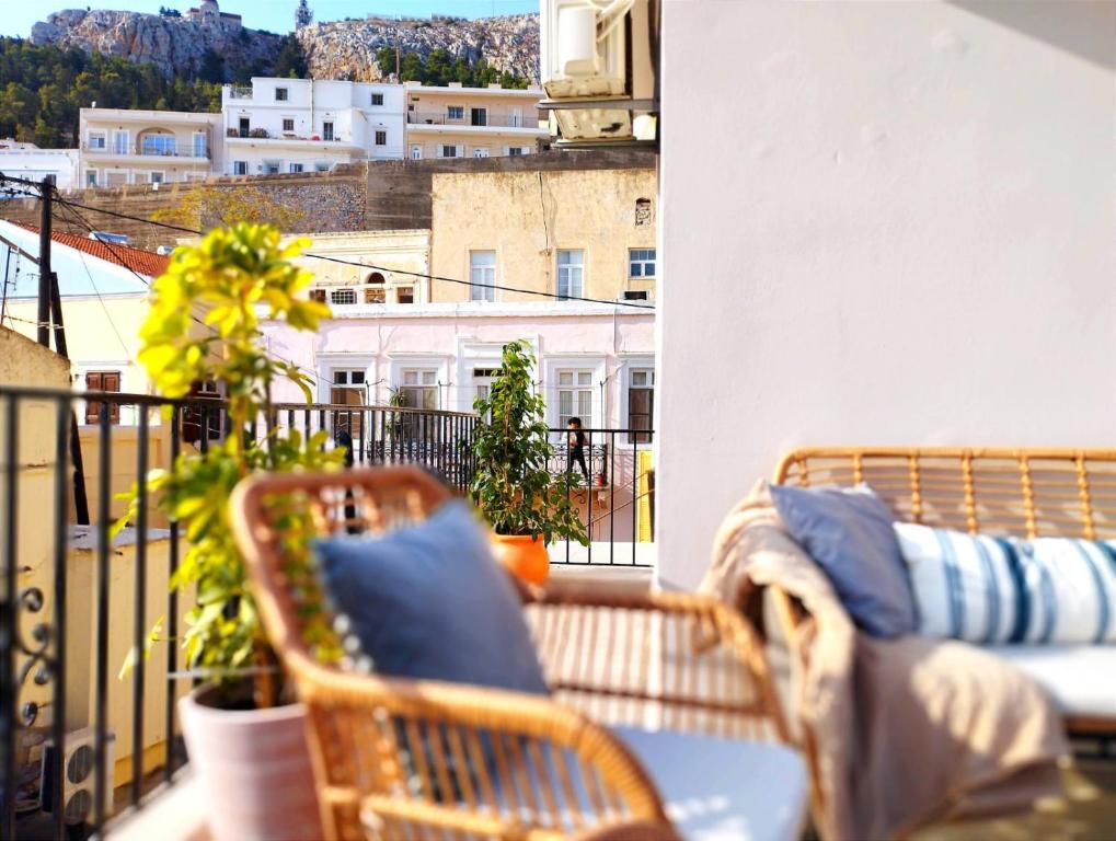 a balcony with a table and chairs on a balcony at Ammoudara's apartments Rooftop in Kalymnos