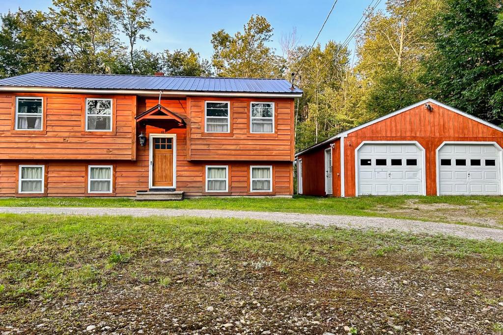 a wooden house with two garage doors and a barn at EZ Sunday Morning in Bethel