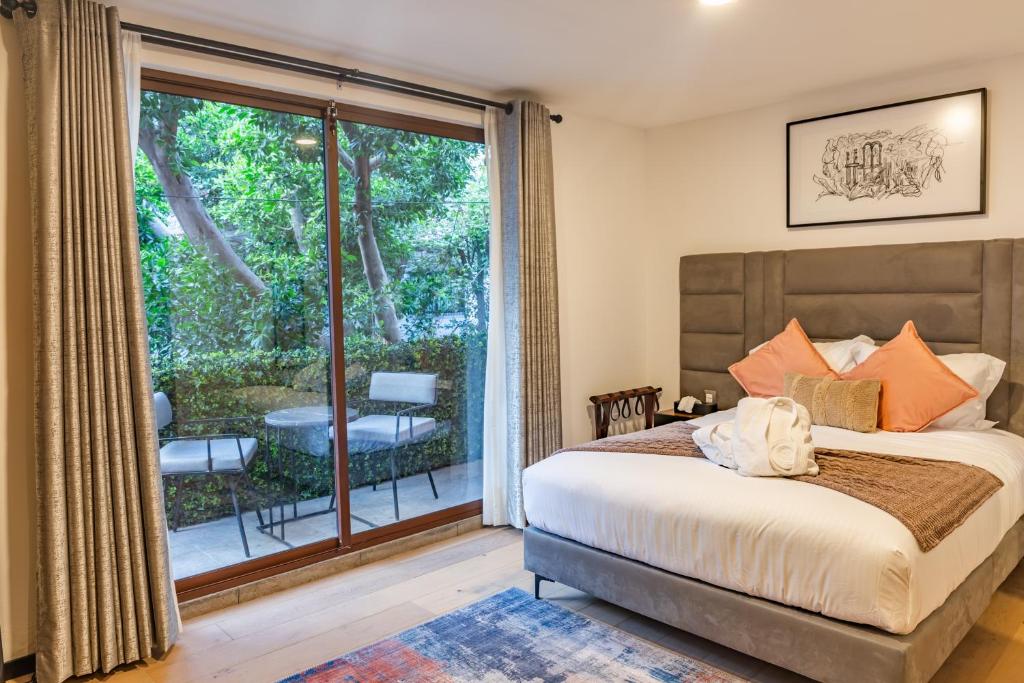 a bedroom with a bed and a large window at Casa Castillo in Mexico City