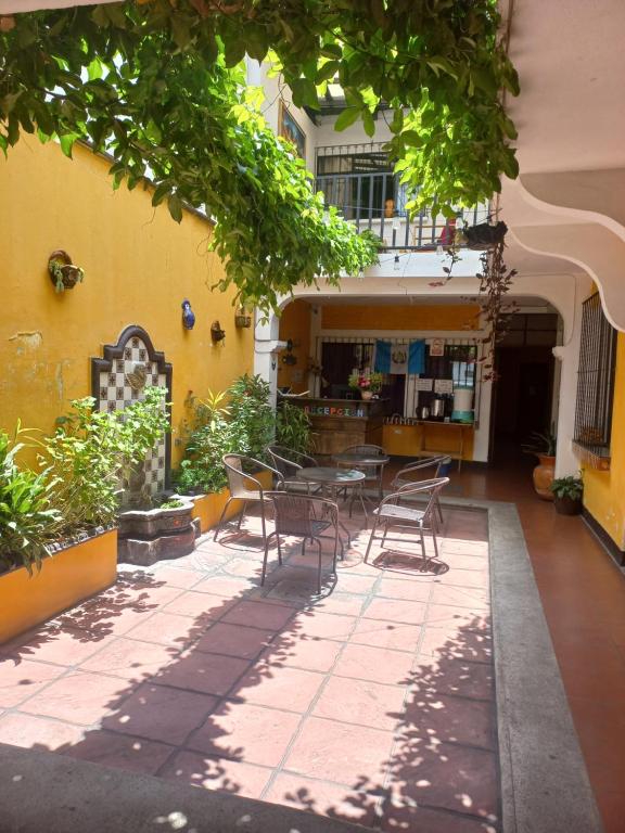 a patio with chairs and a table in a building at Hospedaje el Viajero Antigua ll in Antigua Guatemala