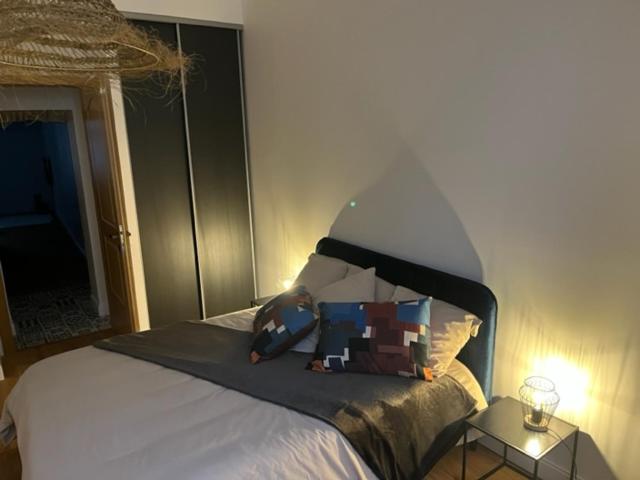 a bedroom with a bed with a mirror and a table at centre ville Chalon sur Saône in Chalon-sur-Saône