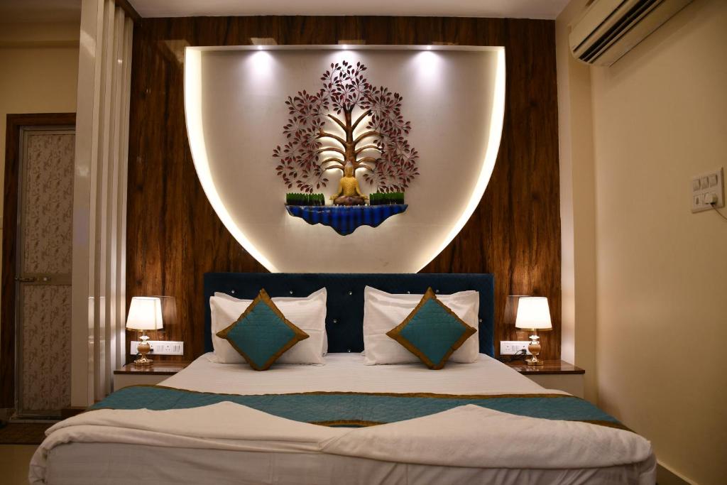 a bedroom with a bed with a large orb above it at Hotel Buddha International in Patna