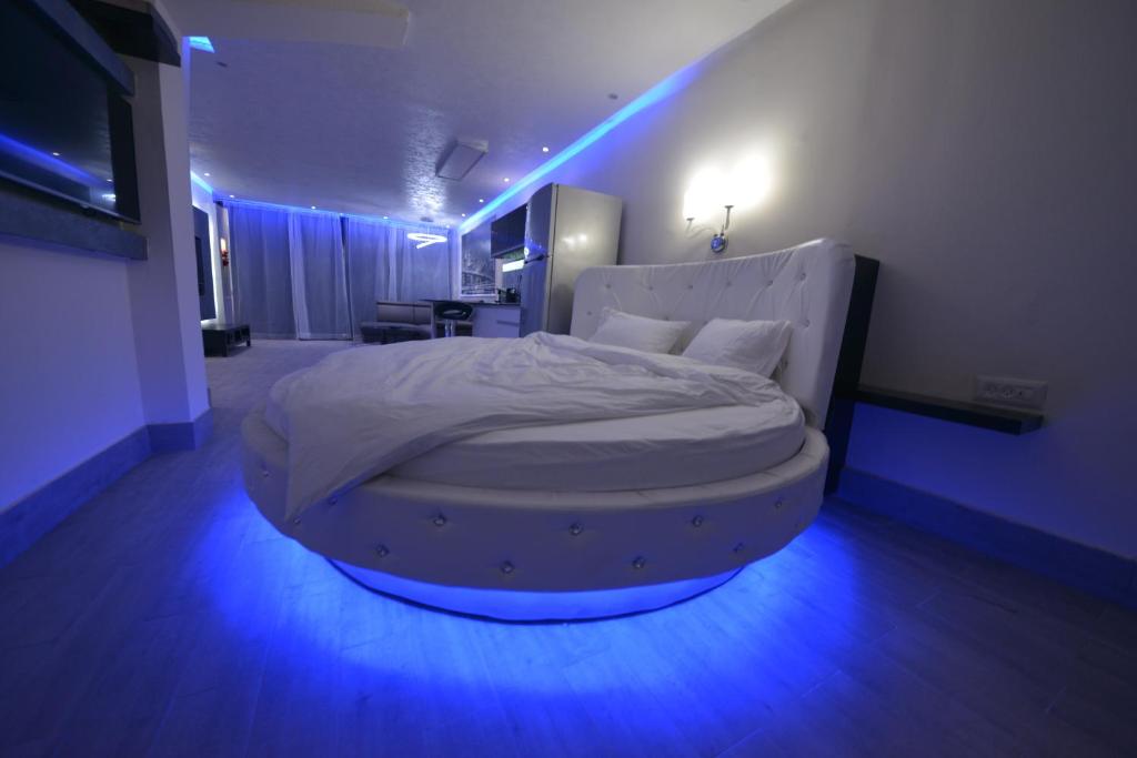 a large bed in a room with blue lights at Jordan luxury suite in Eilat