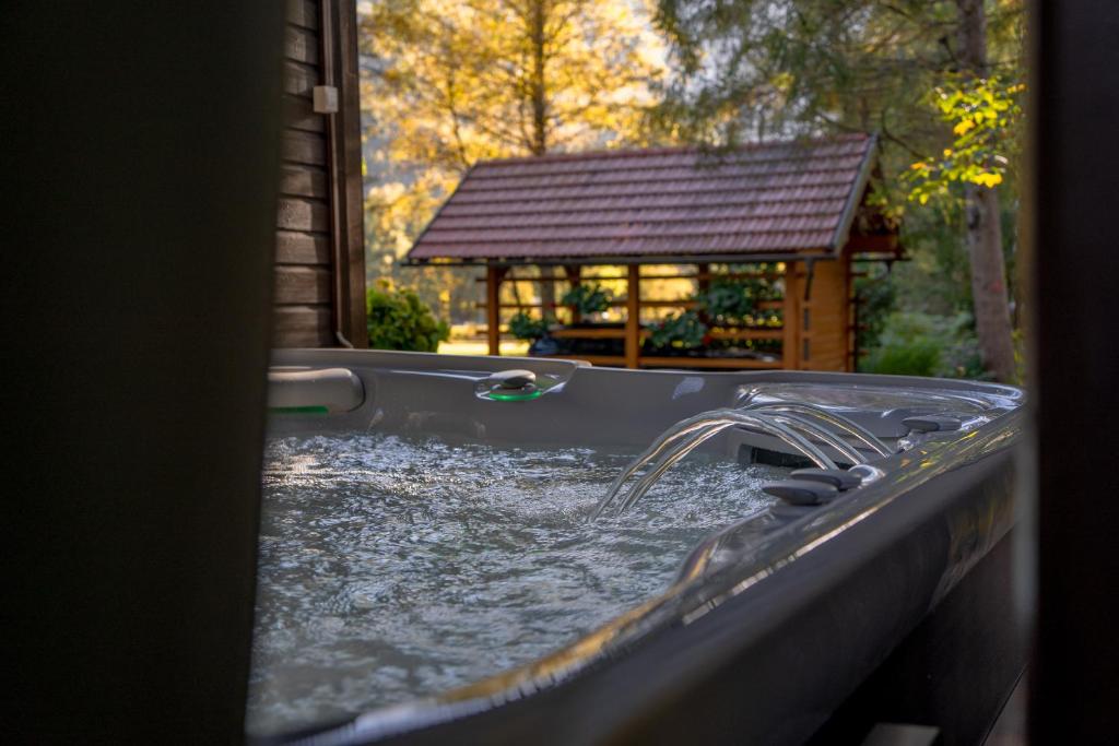 a pool of water with a gazebo at Chalet Lana with Hot Tub in Gozd Martuljek
