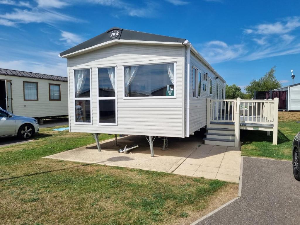 a white tiny house sitting on a sidewalk at 58 Lancaster crescent in Tattershall