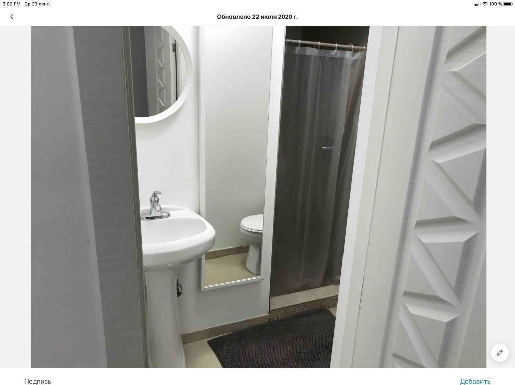 a bathroom with a sink and a toilet and a mirror at Brooklyn Beach Location in Brooklyn