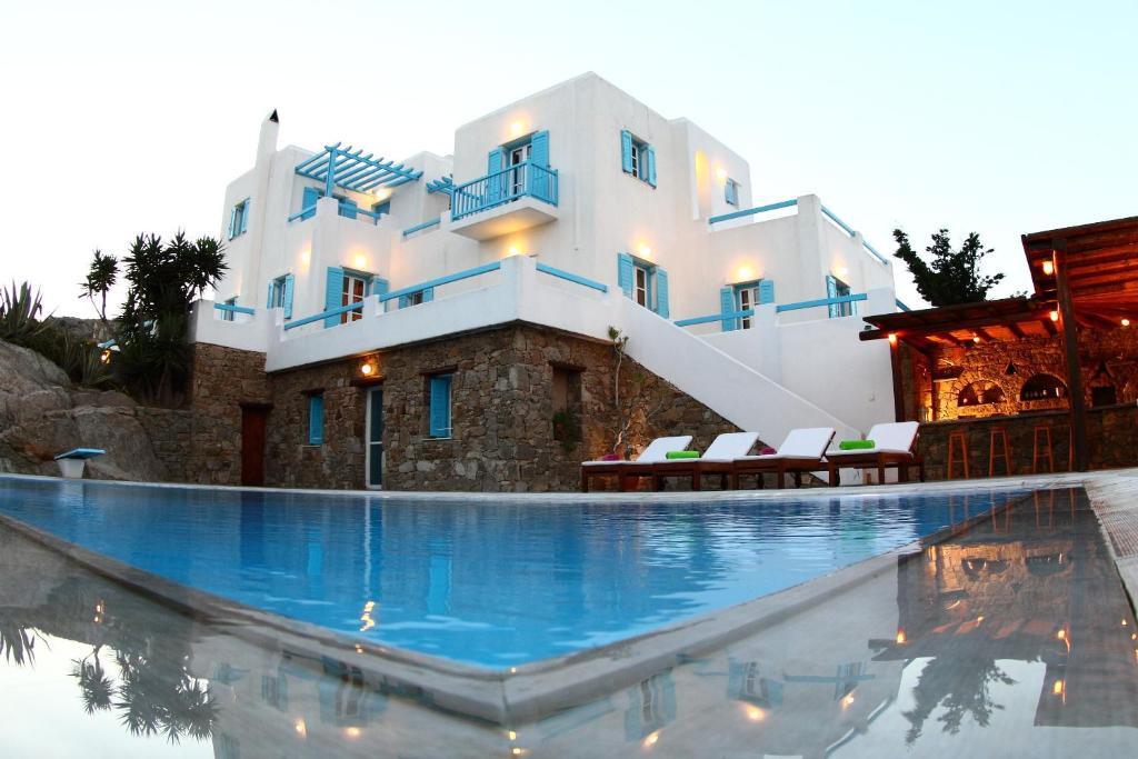 a large swimming pool in front of a house at Galini Villa in Agrari