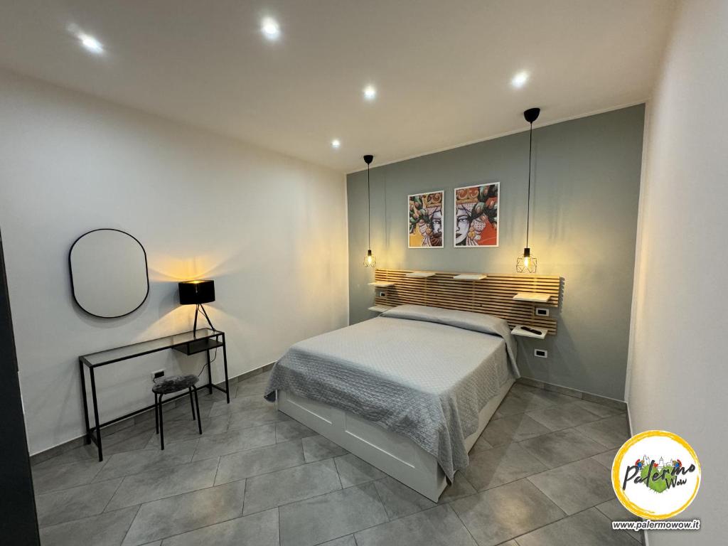 a bedroom with a bed and a mirror and a table at Palermo Wow - Aragona in Palermo