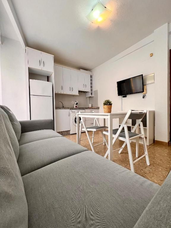 a living room with a couch and a table at APARTAMENTO SANMIGUEL CENTRO in Córdoba