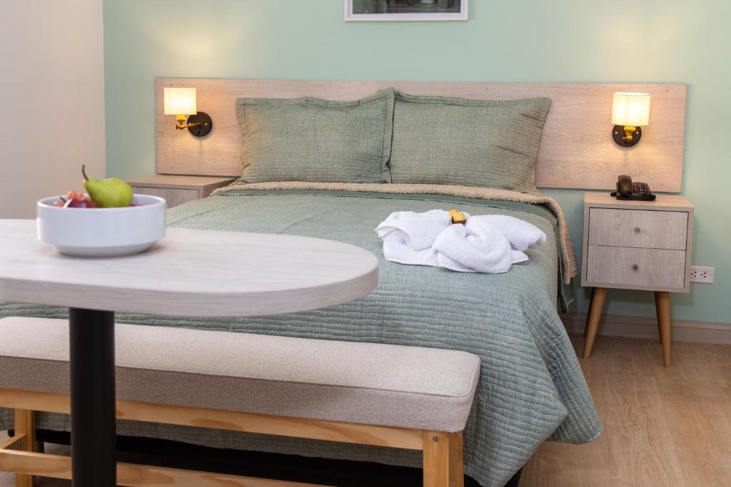 a bedroom with a bed with a table with towels on it at Hotel San Blas in Lima