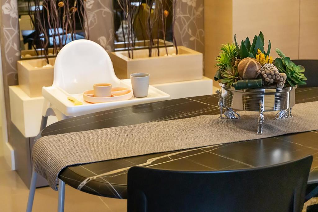 a table with a bowl of fruit on top of it at Downtown Oasis - Spacious Modern 3-BR Flat near Beachpark in Antalya