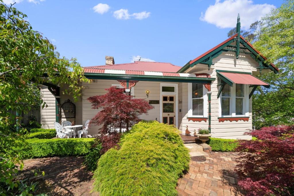 a white house with a red roof at Berdea in Leura