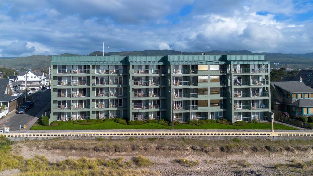 an apartment building with a green roof at Best Western Plus Ocean View Resort in Seaside