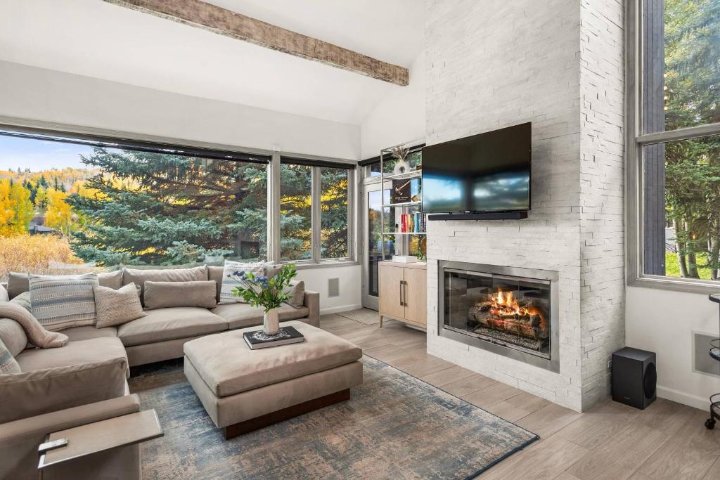 a living room with a couch and a fireplace at Snowmass Villas 3 bedroom plus loft in Snowmass Village