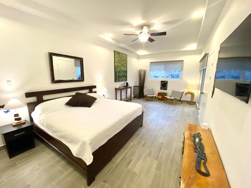 a bedroom with a bed and a ceiling fan at Jacarandas #16, 5 min tamarindo in Villarreal