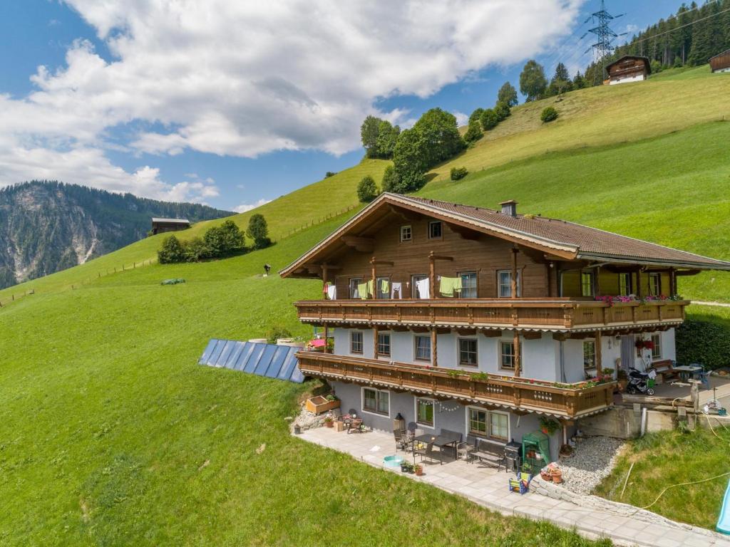 a house on a hill with a green field at Brandtner Bauer in Wald im Pinzgau